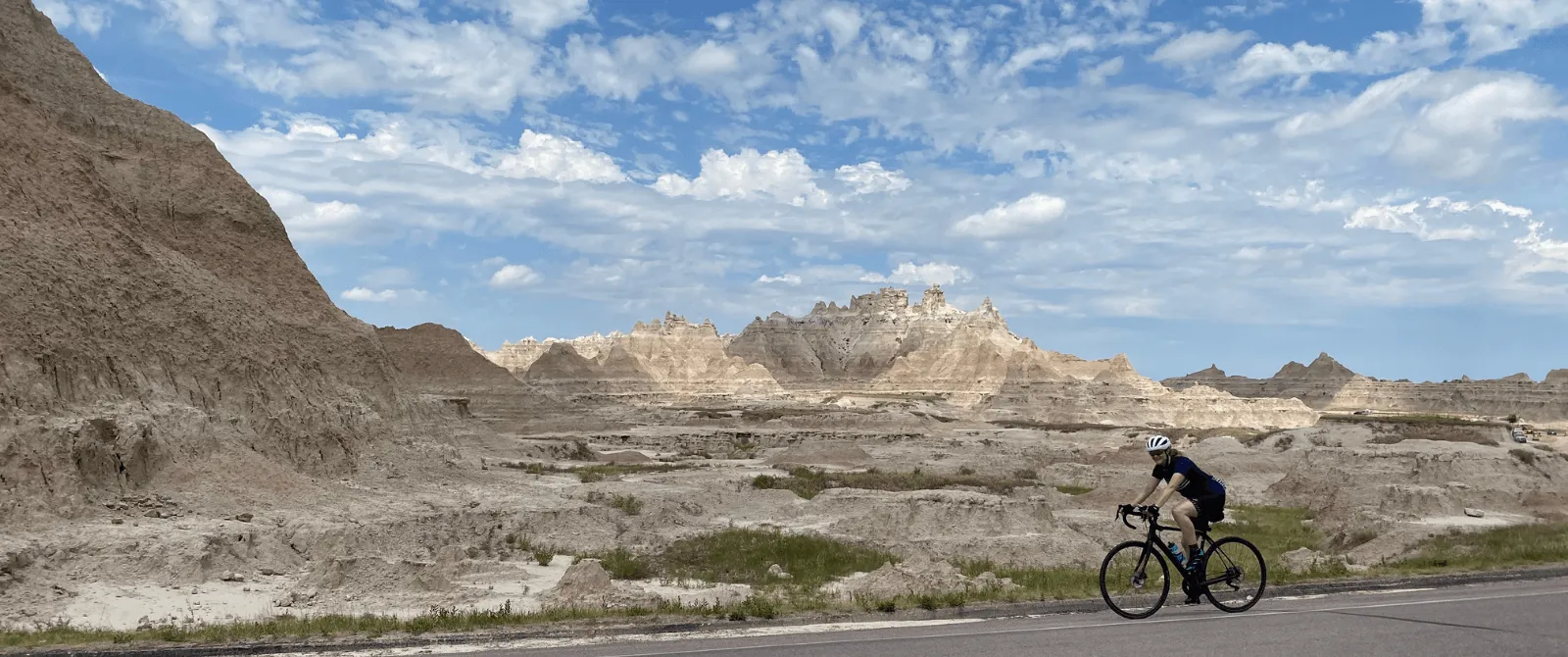 person riding a bike with awesome South Dakota view in the background