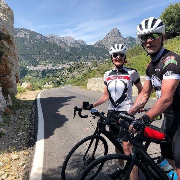 2 people stopped on their bikes on the side of the road in andalucia