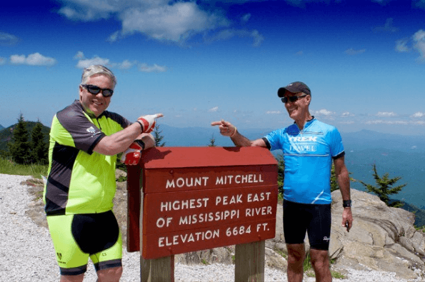 Two cyclists all smiles at Mt Mitchell Summit