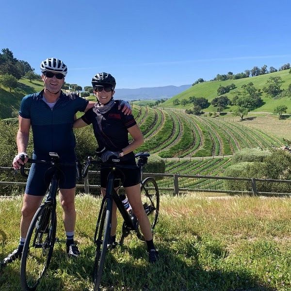 couple standing over their bikes with california landscape in the background