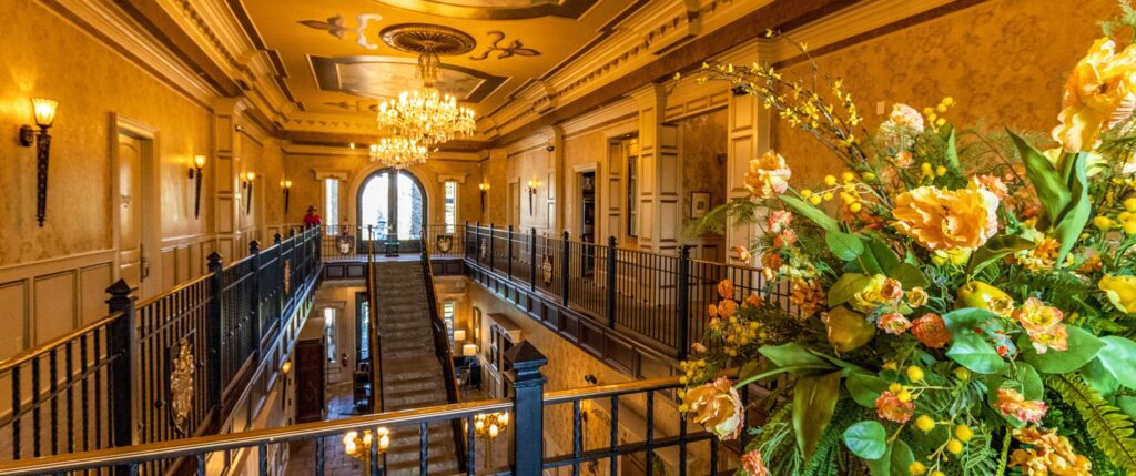 Upstairs view of the Kentucky Castle lobby with yellow flowers in foreground