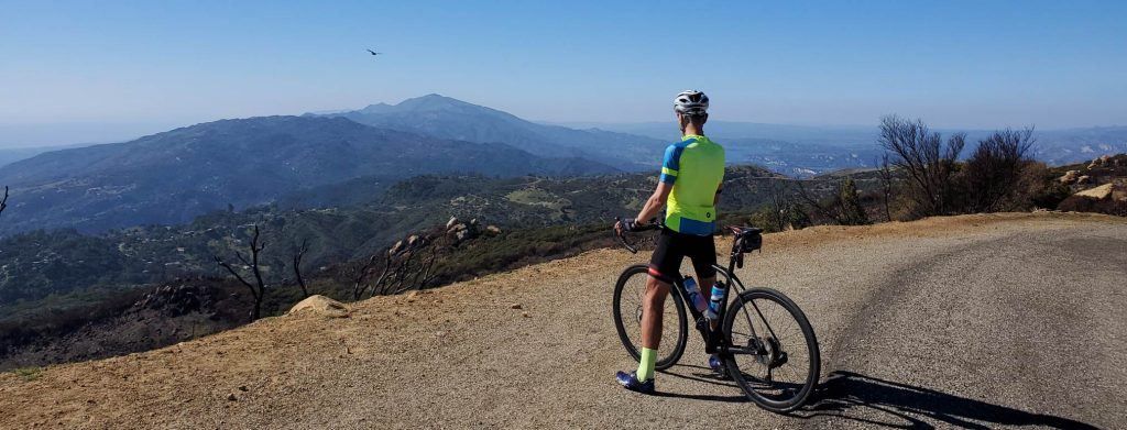 Person on a bike looking over a cliff