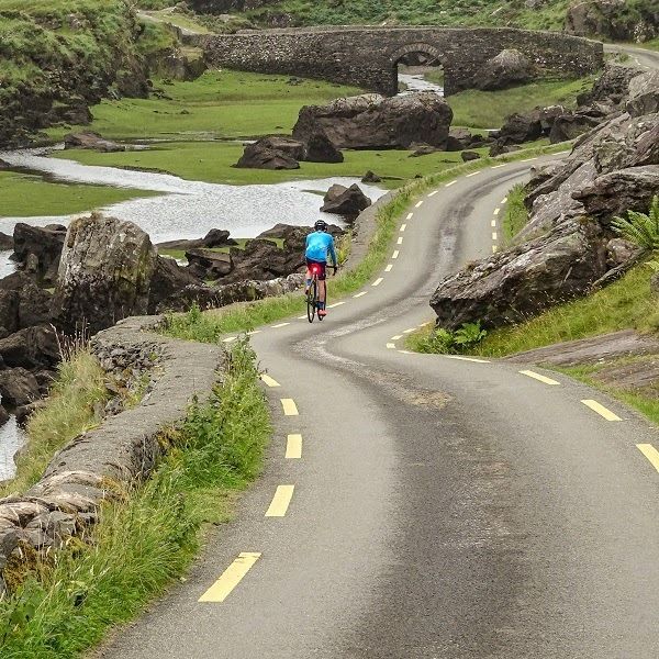 A person riding a bike away from the camera