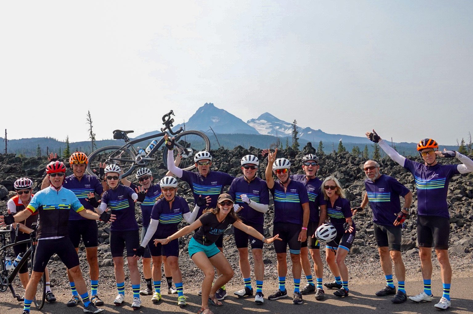 Group at the top of McKenzie Pass Highway in Oregon with Volcanos in the background