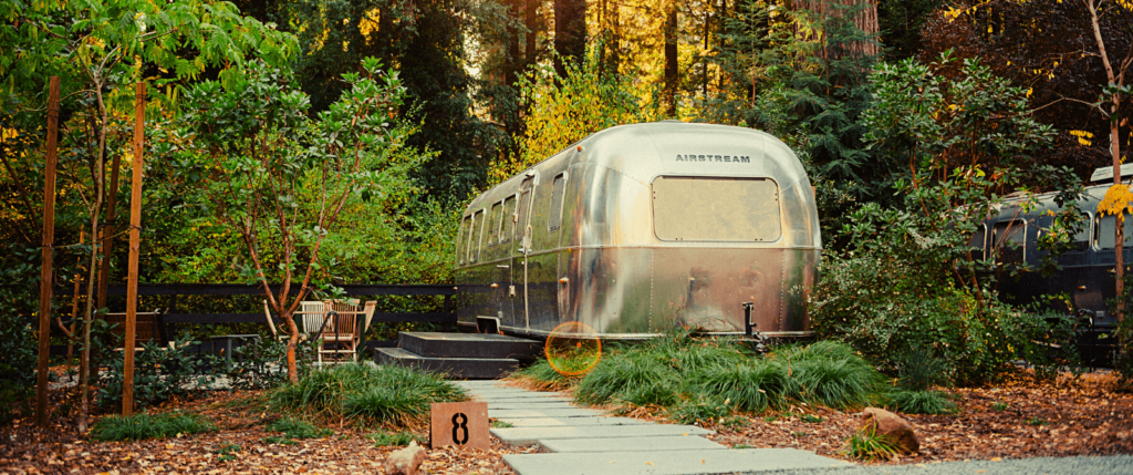 airstream camper set up in the woods