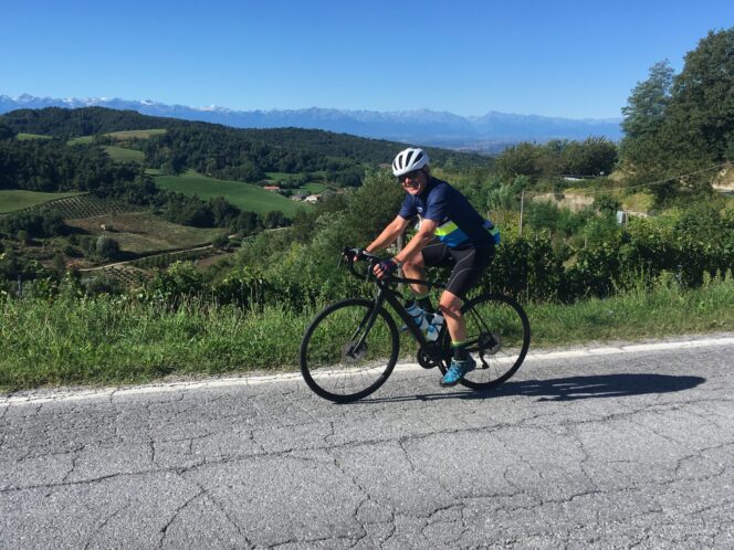 Cyclist riding with view of rolling hills in the background