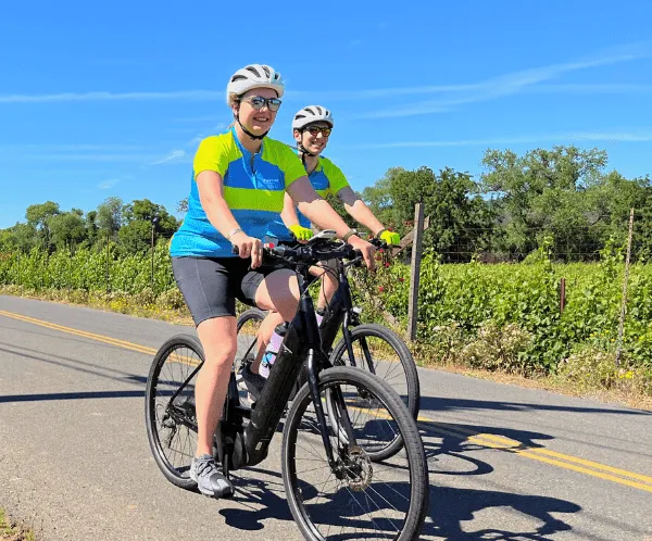 Two people riding bikes on a sunny day in California