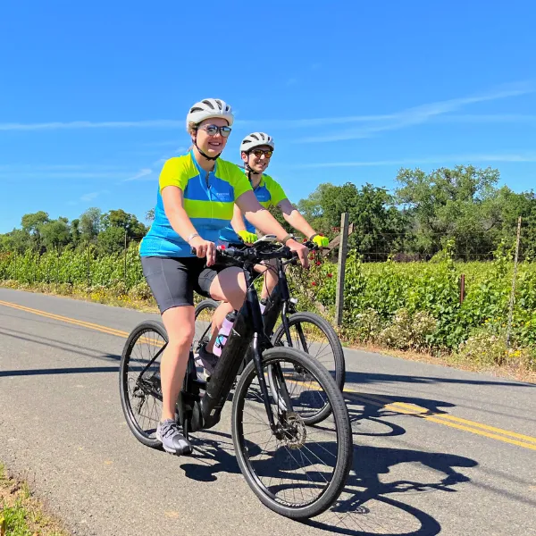 Two people riding bikes on a sunny day in California
