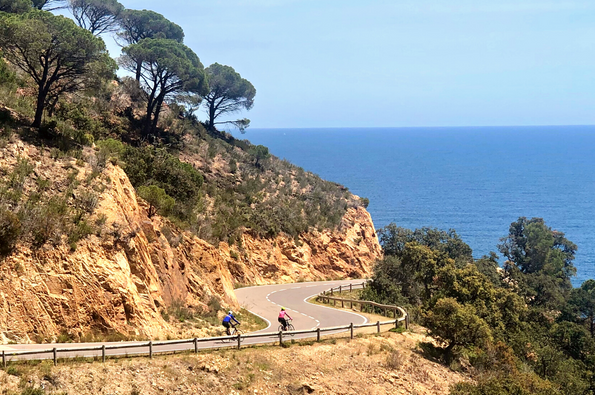 Cyclists rounding a corner on the costa brava coast