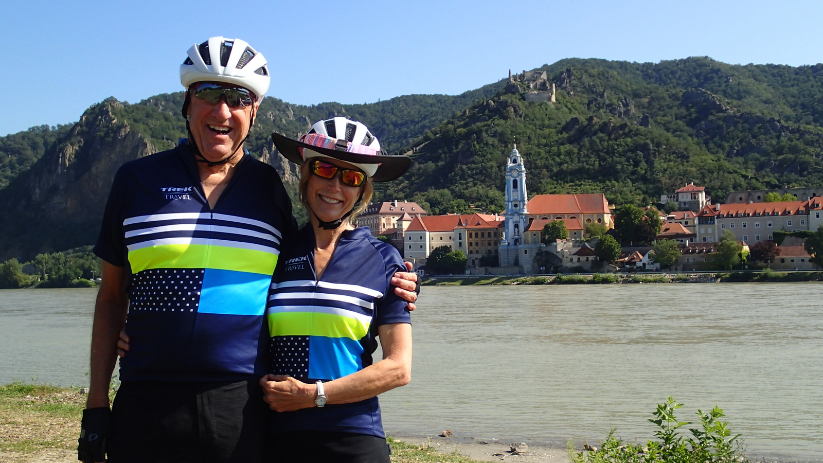 Couple standing in front of river with Durnstein behind