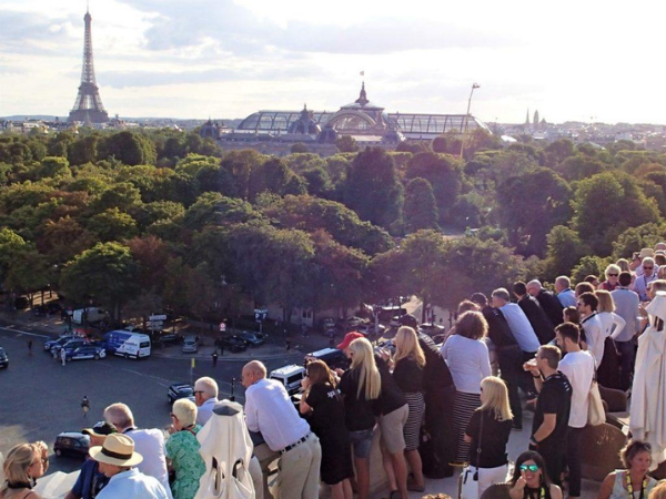 People watching the TDFrace with the Eiffel Tower in the background