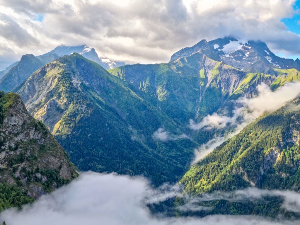 A view of tree covered mountains and low-lying clouds