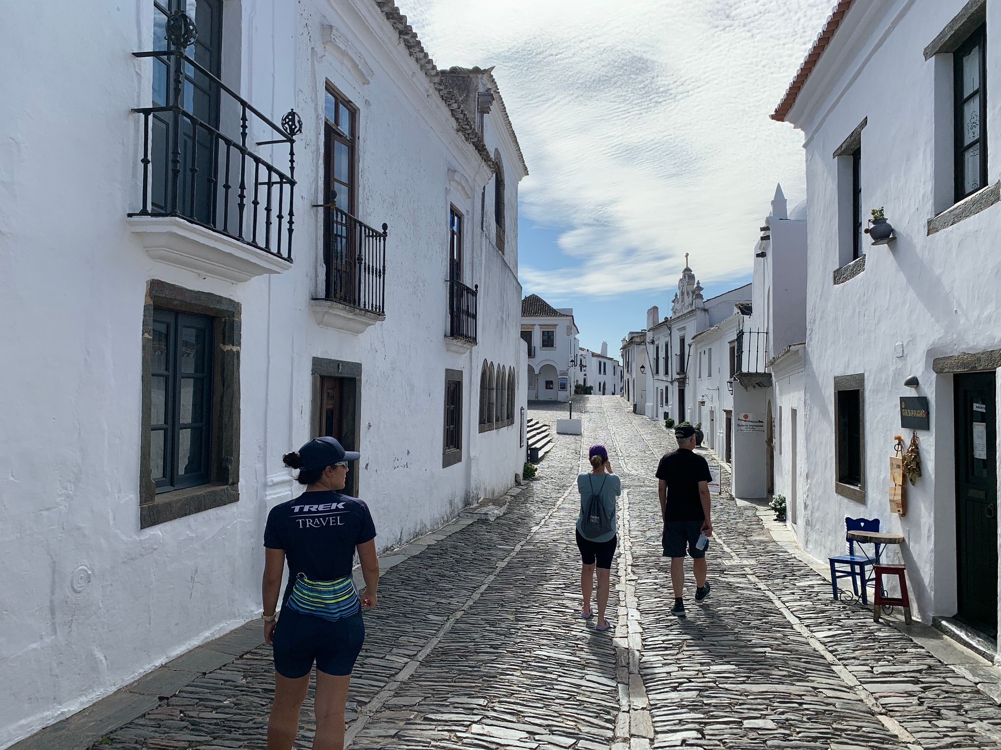 Three people walking on the streets of Monsaraz