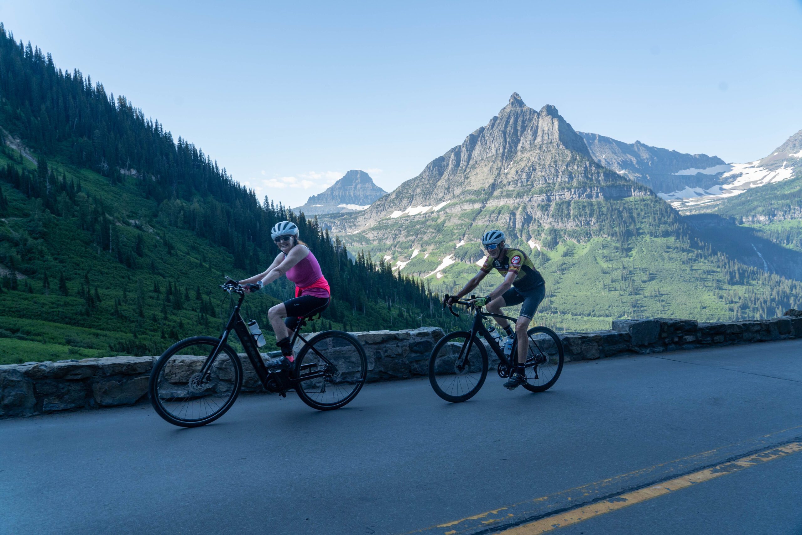 Two cyclists ride 'Going to the Sun' Road together in Glacier National Park