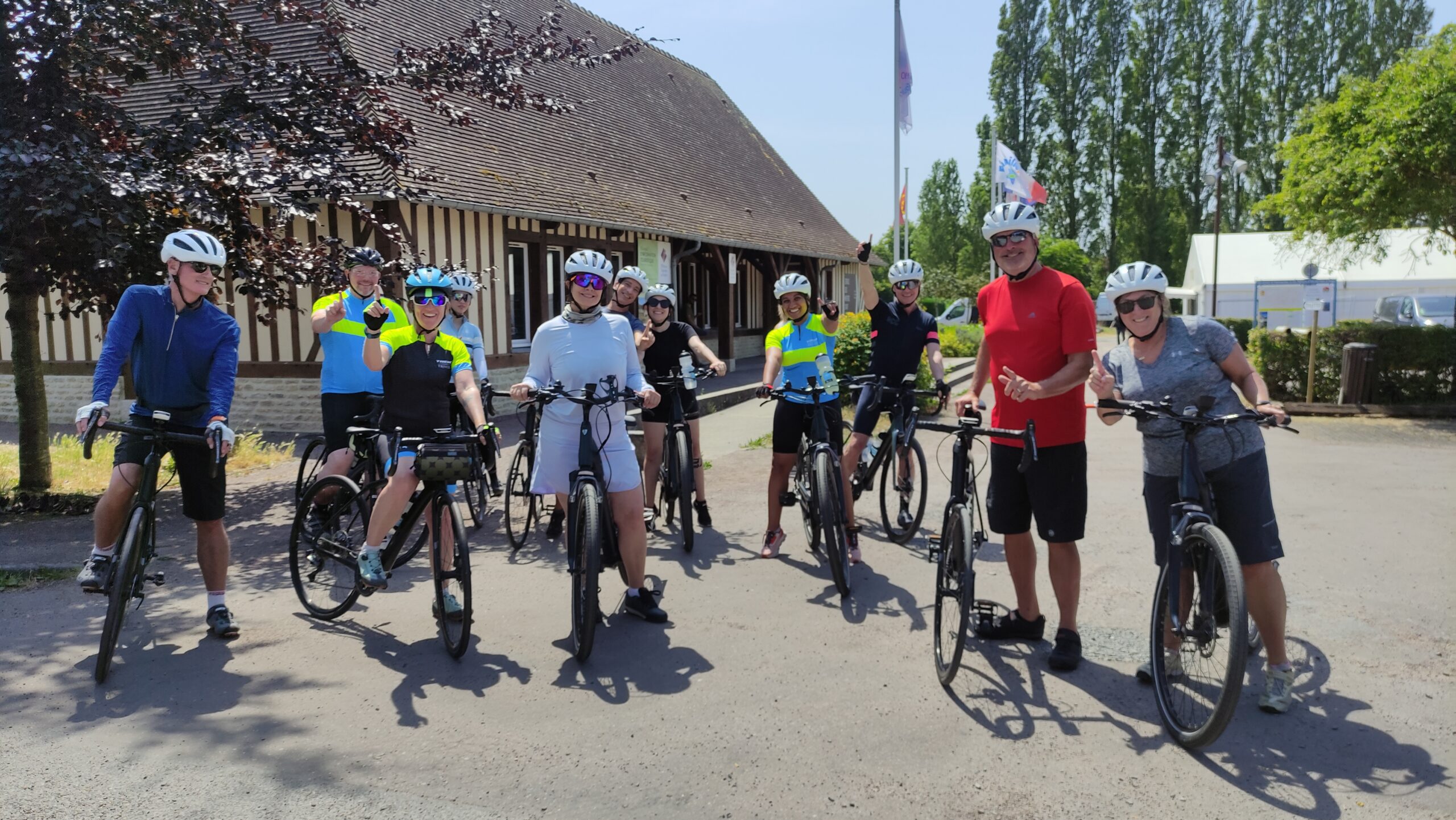 A group of cyclist in Normandy smiling at the camera