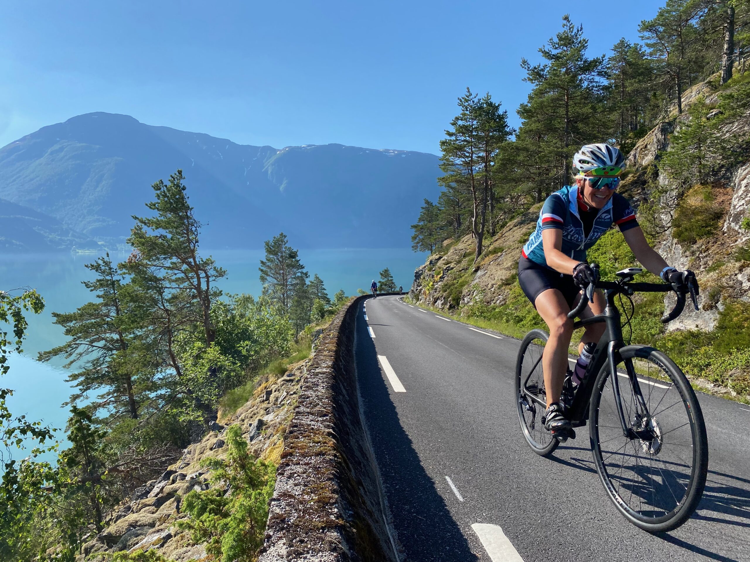 NO:cyclist riding along the fjord