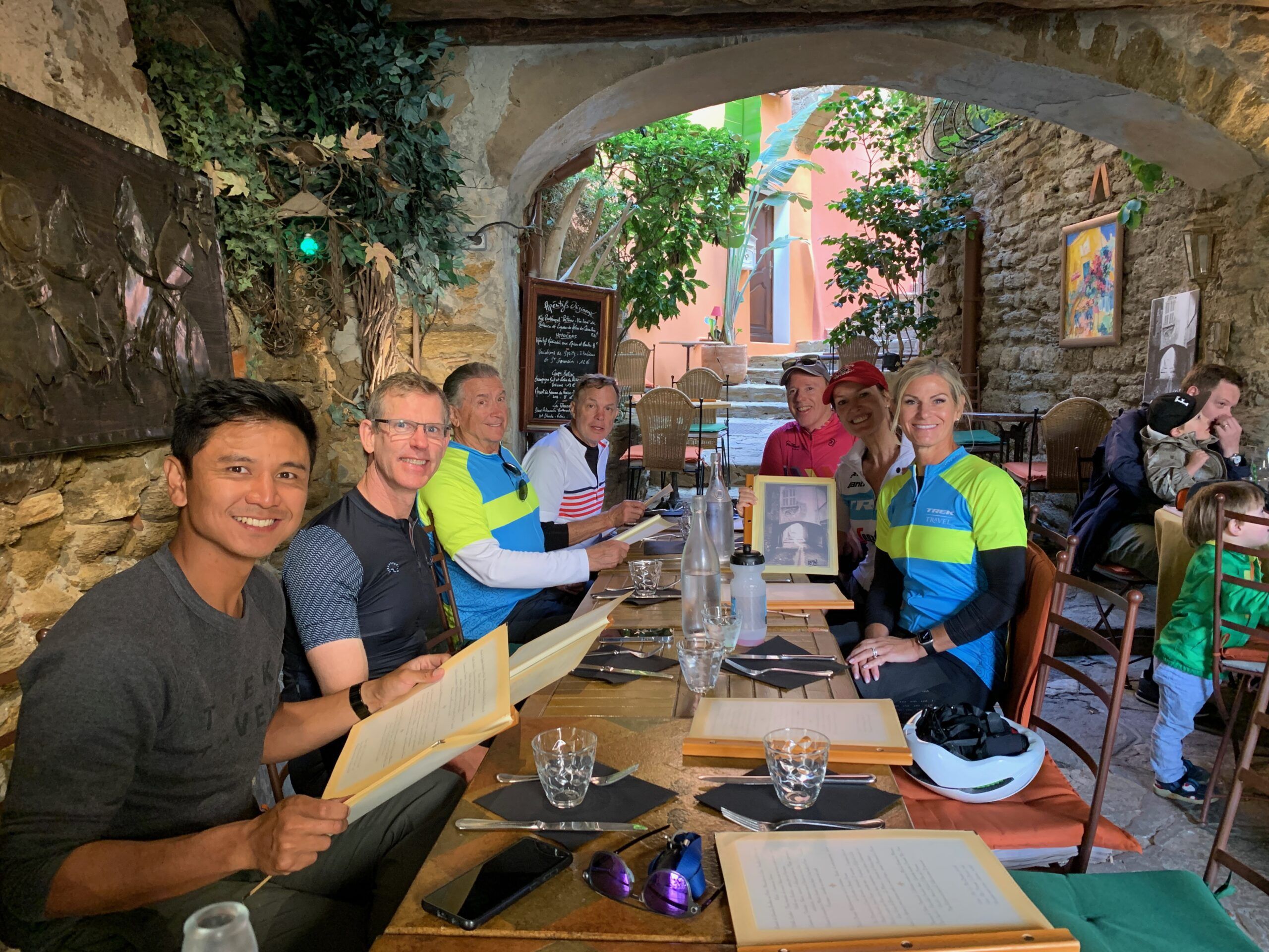 A group of people sitting at a table restaurant, smiling at the camera