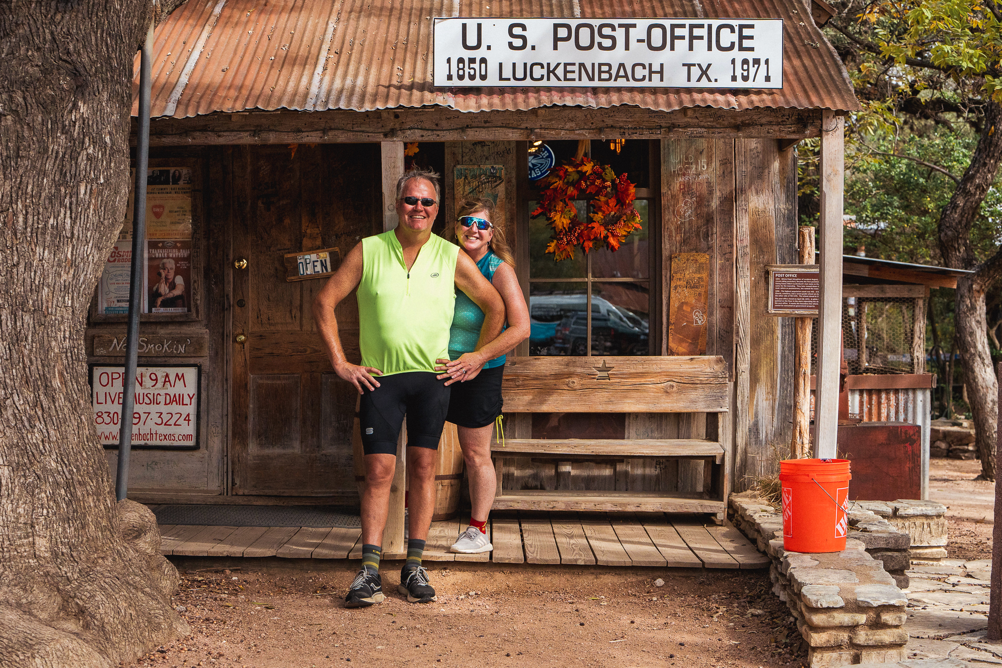 couple standing in front of historic post office in Luckenbach TX