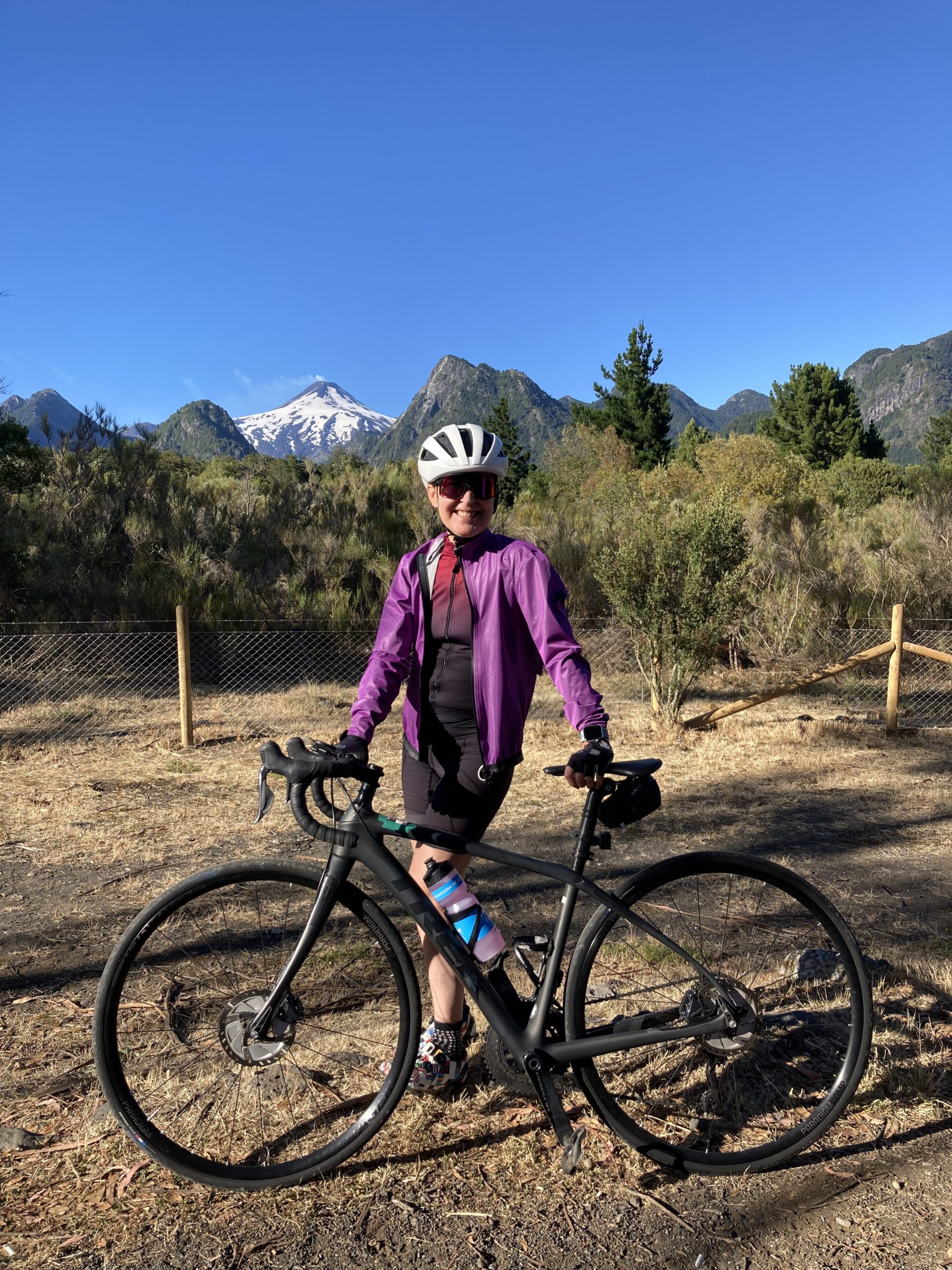 Cyclist posing with volcanoes in the background