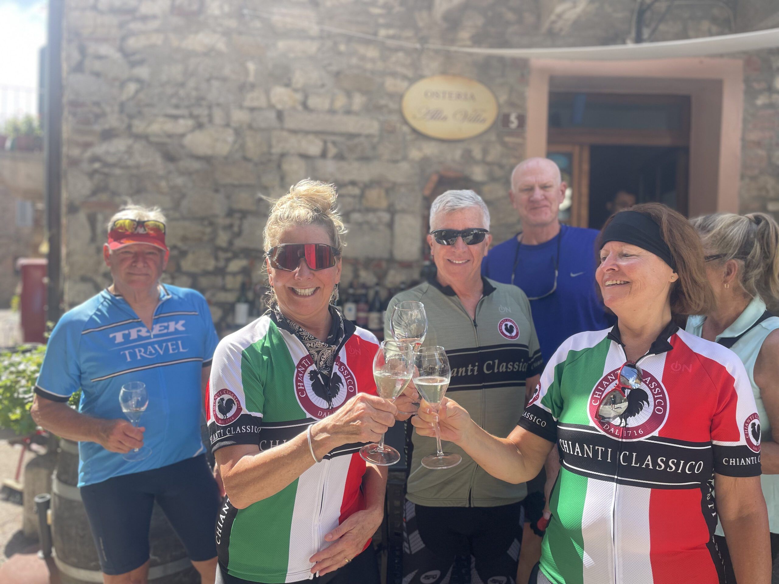 Group of cyclists with wine glasses