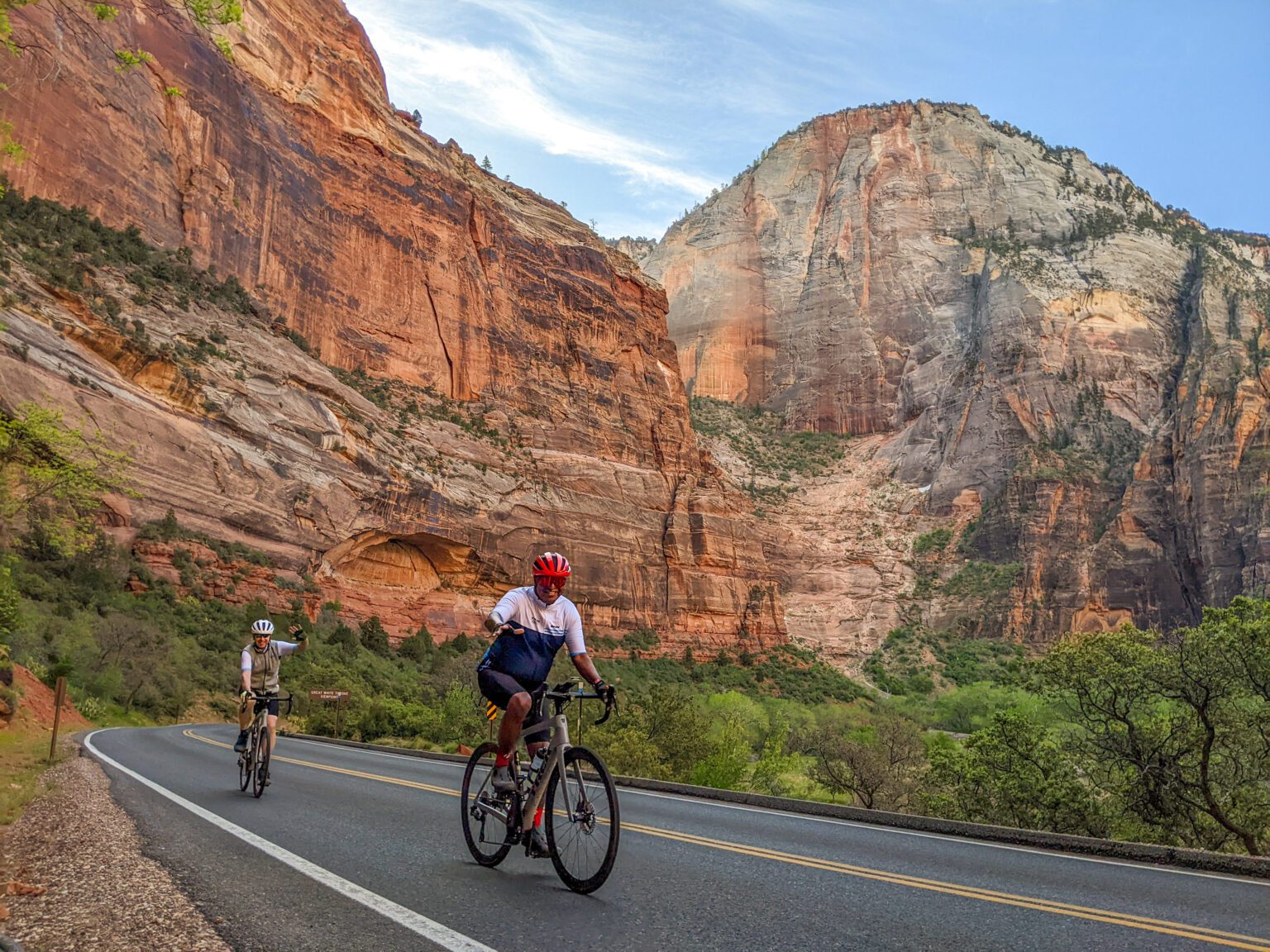Two cyclists ride through rock strata in the Utah canyonlands