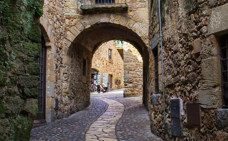 Archway on a cobbled street in Girona