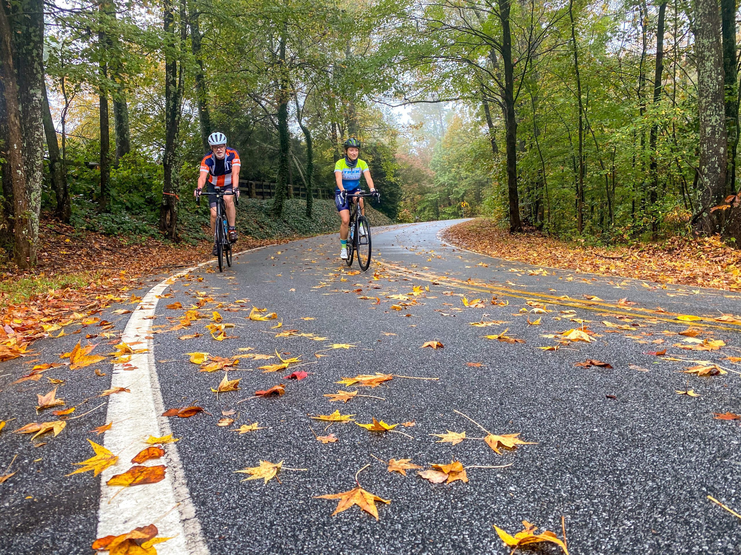 Two cyclists riding in Greenville, South Carolina in the Fall.