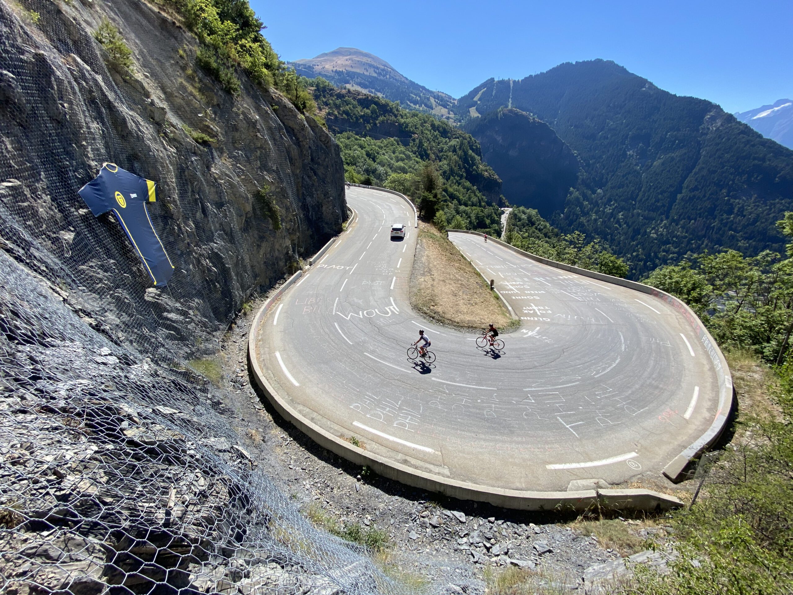 A switchback on the road leading to Alpe d'Huez with two cyclists