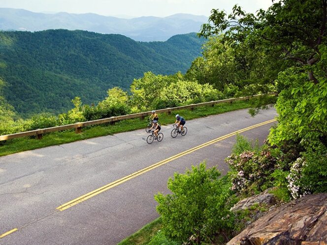 two people riding their bike near a beautiful Greenville, NC scenery