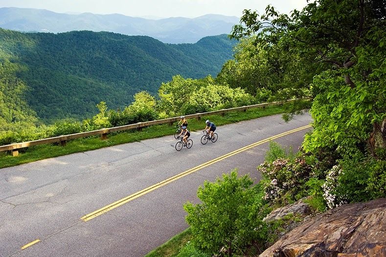 two people riding their bike near a beautiful Greenville, NC scenery