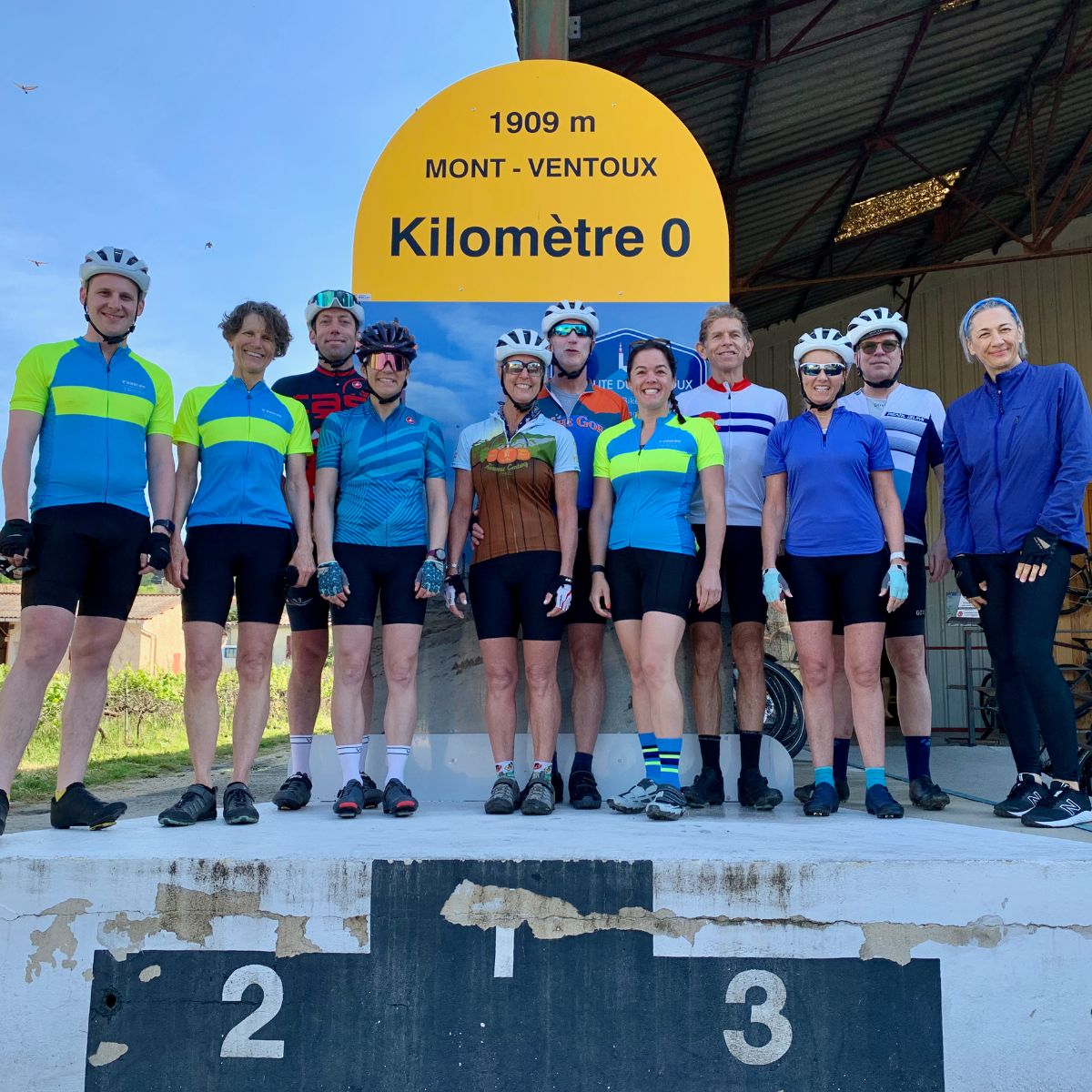 group of people standing on a podium with their bike helmets on