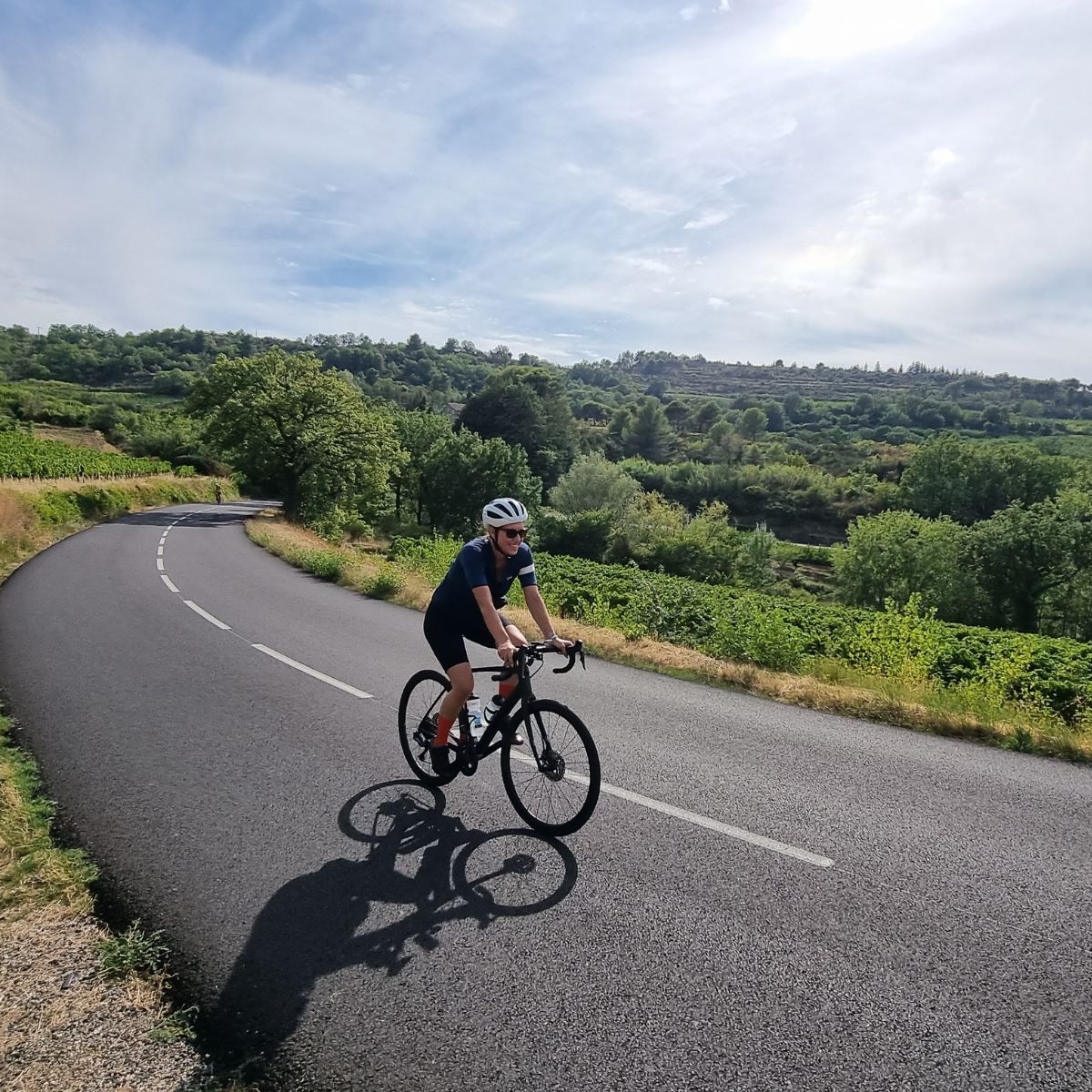 person riding their bike on a paved road in Provence