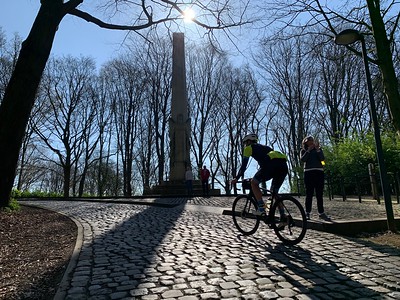 Rider cycling on a cobbled hill in Belgium