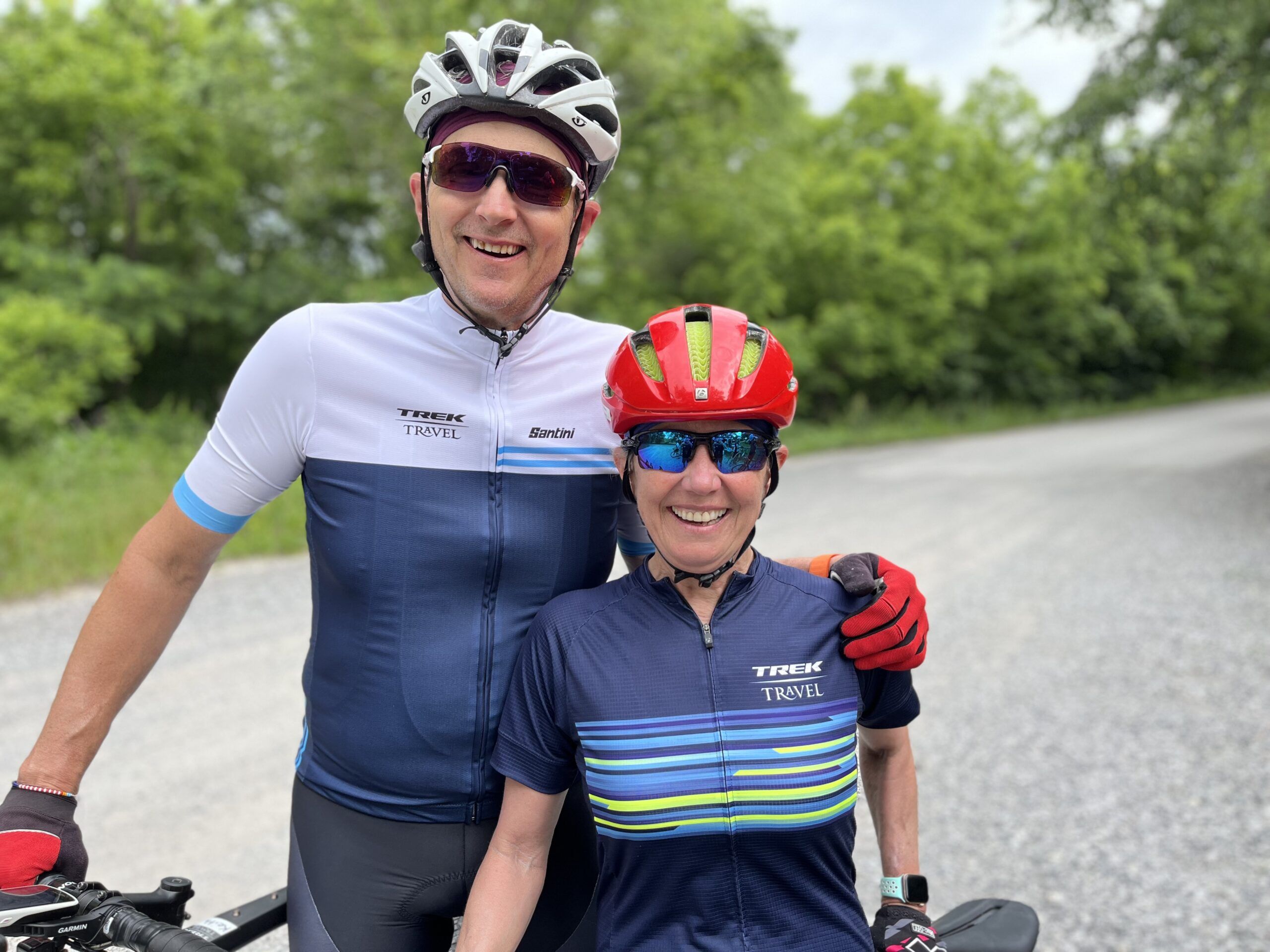 Smiling cyclists on gravel road