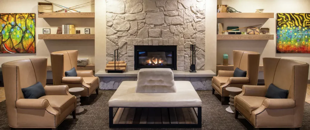 Fireplace with white mantle and couch in lobby of Doubletree hotel