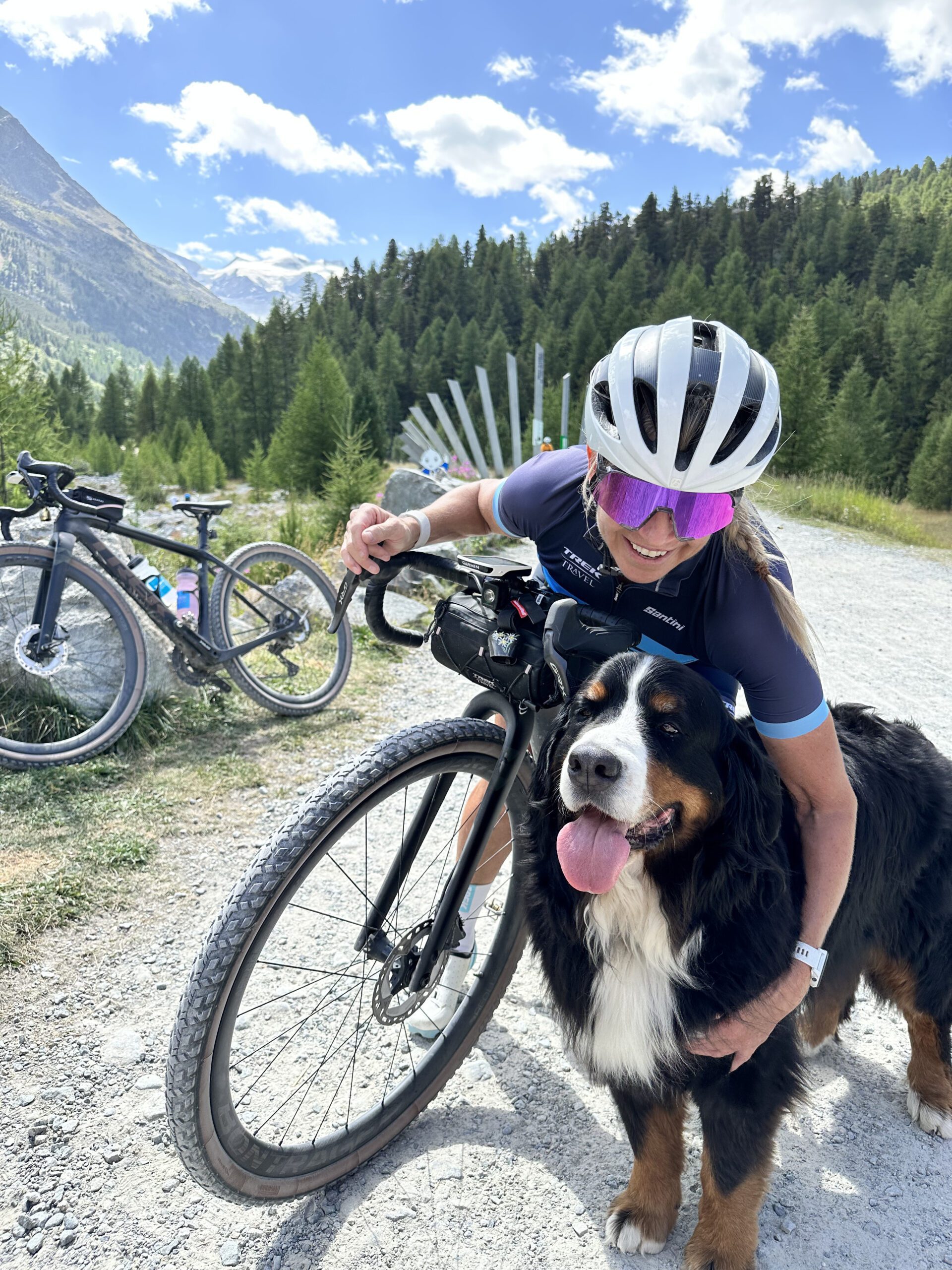 Guide Lisa Lieb hugging a beautiful Burnese Mountain dog