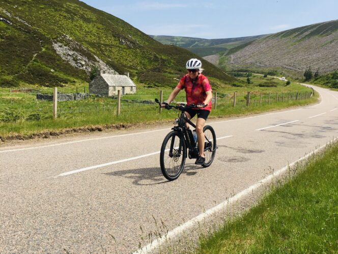 Woman riding an ebike in the countryside of Scotland