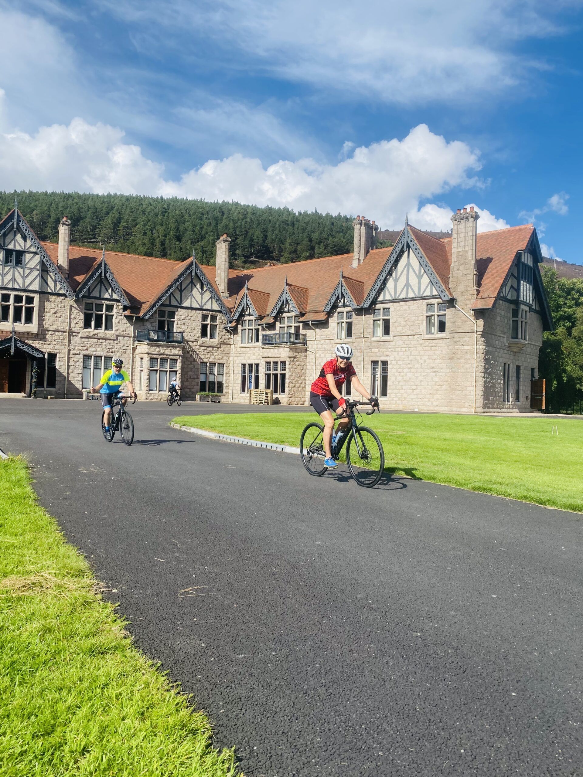 Two cyclists riding on a driveway