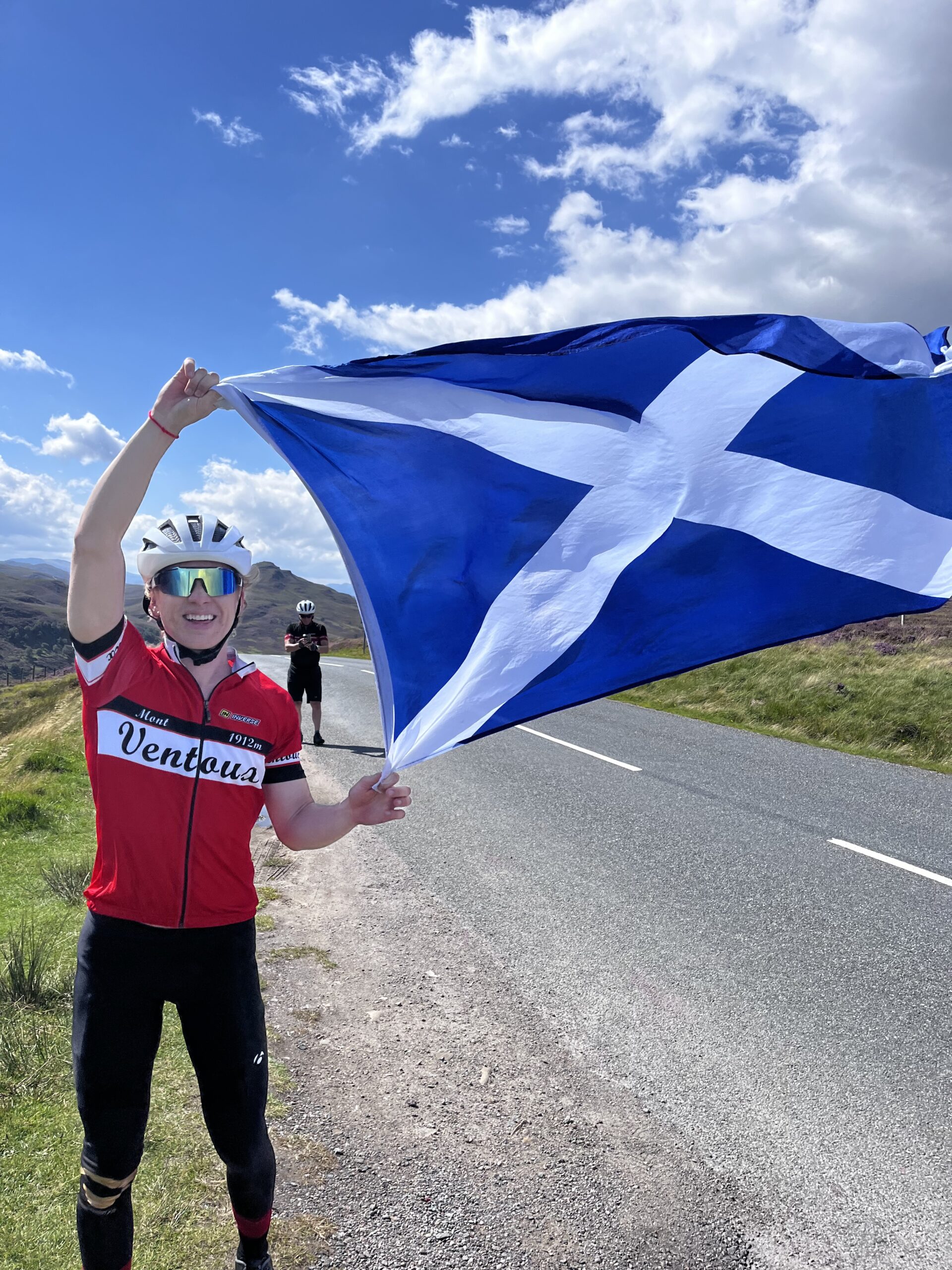 Cyclist waving the Scottish flag