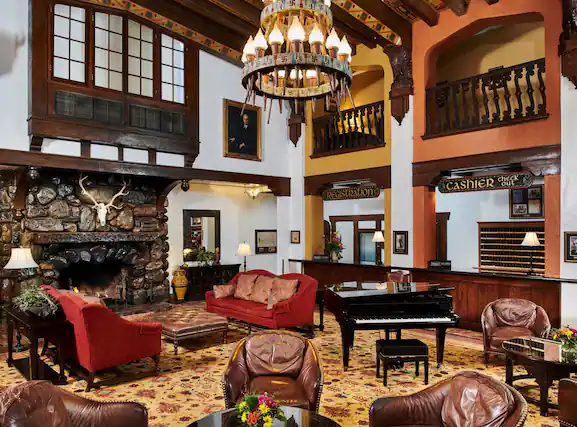 Historic lobby of Hotel Alex Johnson with chandelier and Native American art