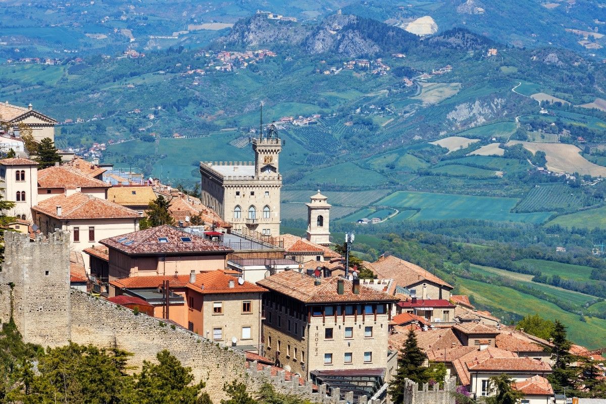 Castle overlooking a vast valley with mountains in the background