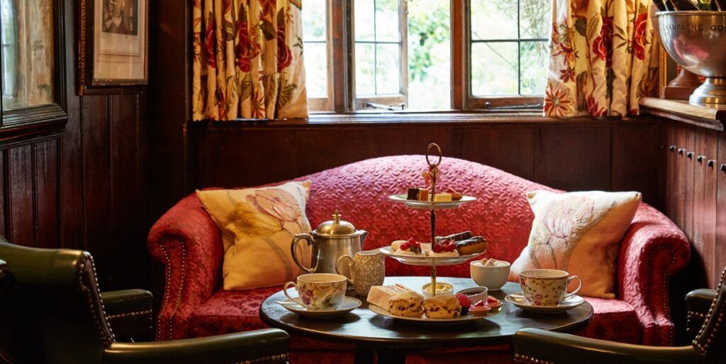 Afternoon tea laid out on tabel in front of old timey couch