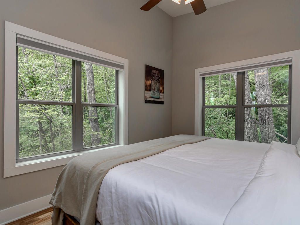 Interior shot of bedroom looking out the window at Pilot Cove cabins