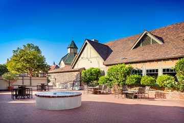 Exterior view of Corque hotel and tiled patio area