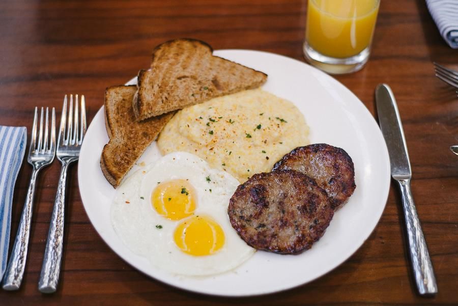 plate of eggs, sausage, grits and toast