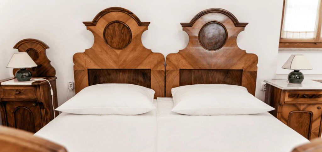 A double bed with ornate wood headboards
