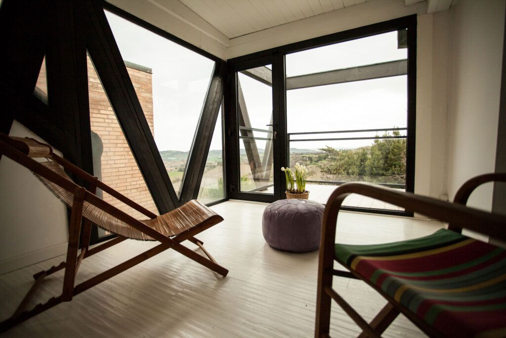 Two wooden lounge chairs in hotel room