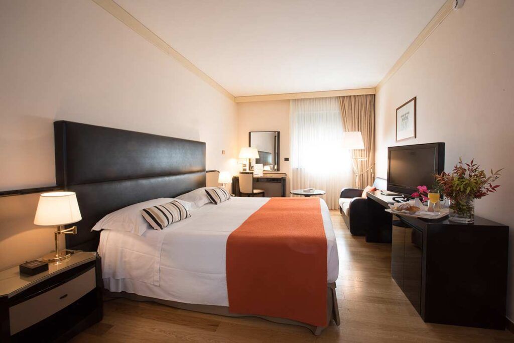 Luxury hotel room with leather headboard and fine linens