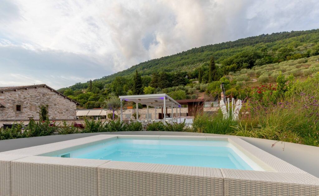 Outdoor pool on the terrace near lush hillside