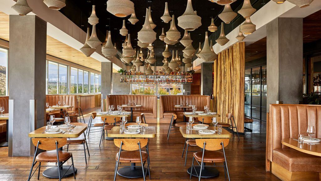 Dining area with stylish ceiling lamps and banquets